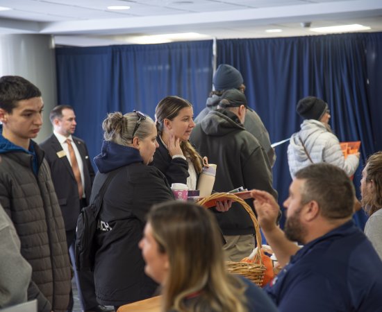 Prospective students gathered in the Concourse to talk with members of the Utica community at a November 2025 Open House event.