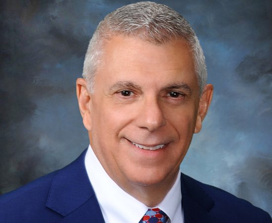 Anthony Picente in white shirt and blue suit jacket.