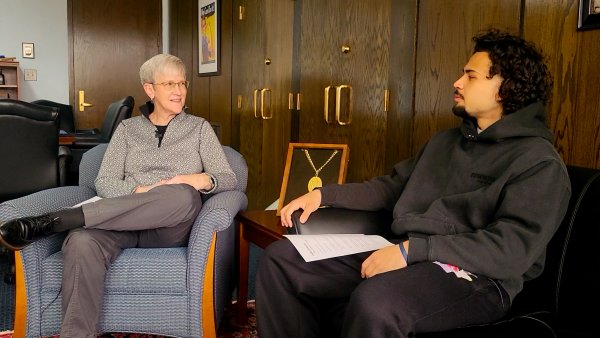President Stephanie Nesbitt and Communication & Media major Neruda Perdomo ’26 sit in two chairs talking with each other.
