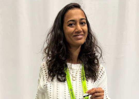 Dr. Rutal Mahajan stands in front of a white curtain