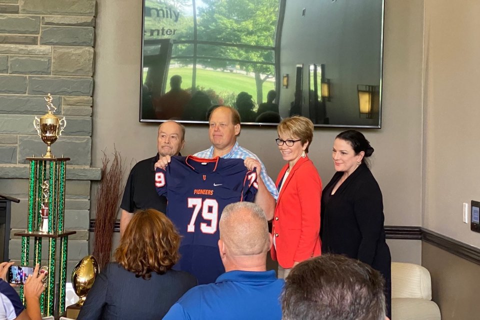 Floyd Fire Chief John Stark receives a jersey  as an honorary Pioneer Captain.